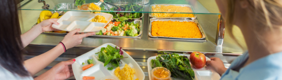 Students in cafeteria line being served a delicious meal Students in cafeteria line being served a delicious meal